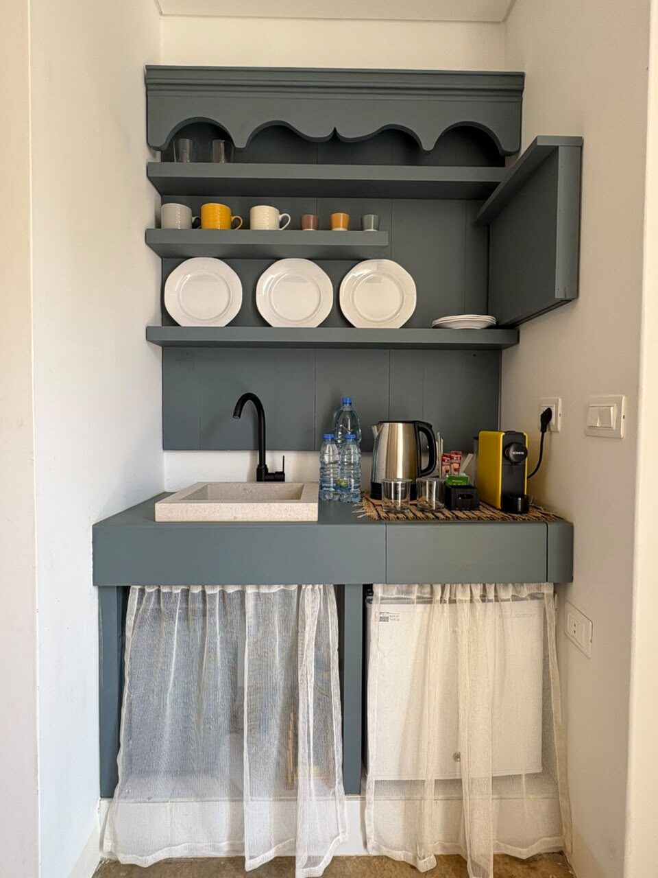 Echo coffee corner with a blue-grey cabinet, plate rack, kettle and espresso machine