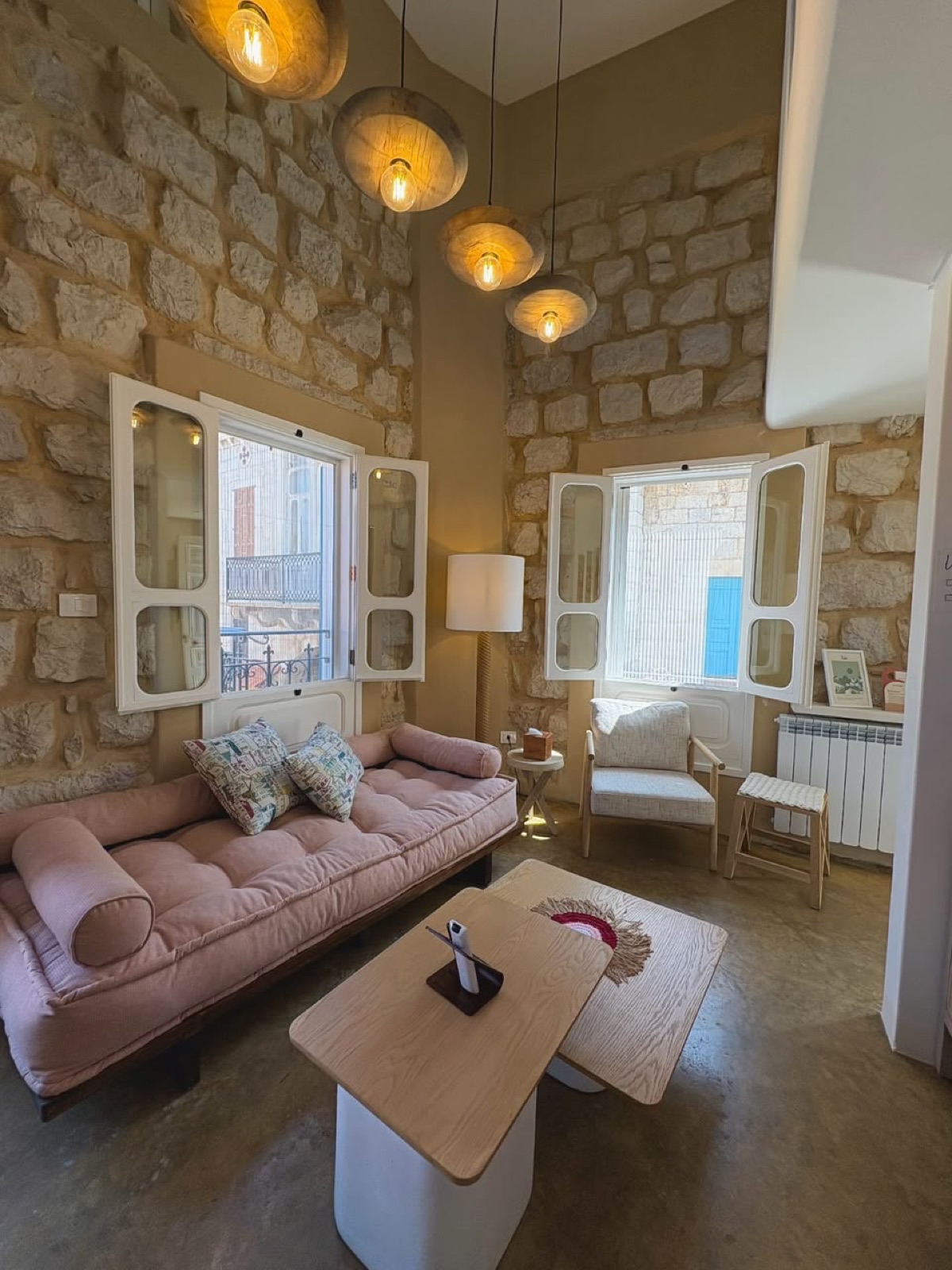 Tale room lounge with rose daybed under pendant lights