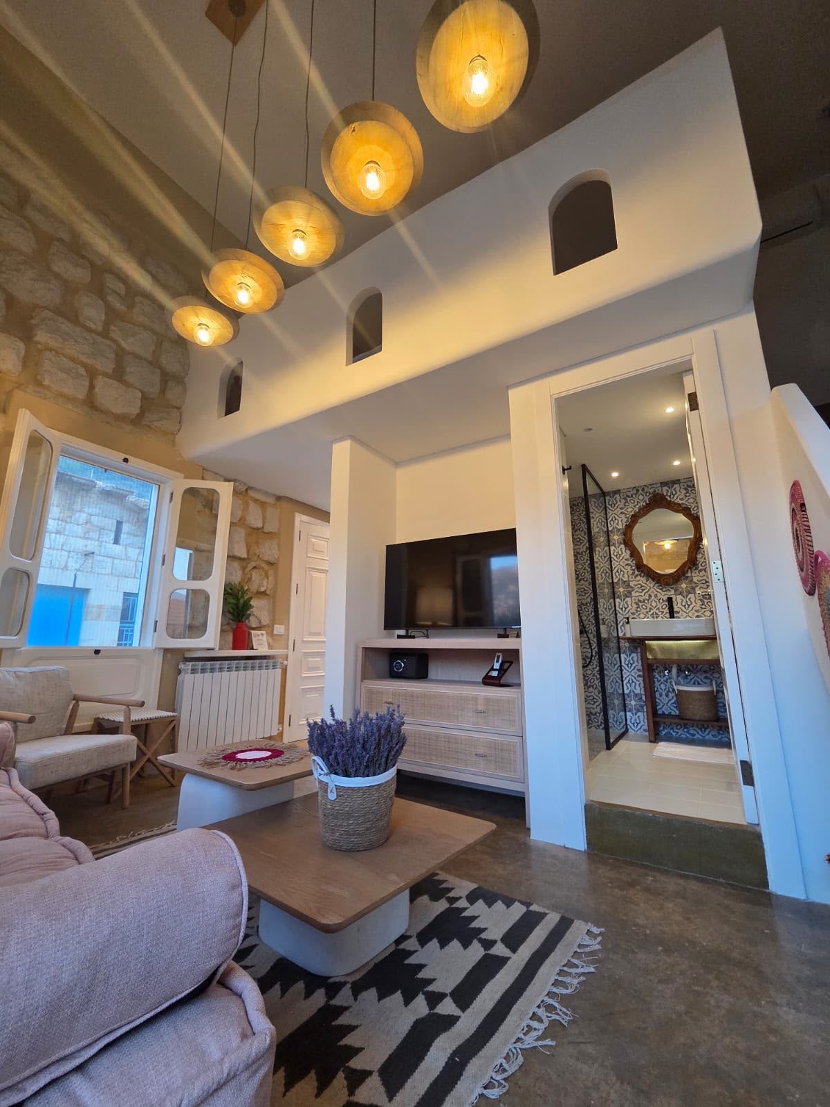 Tale room mezzanine with arched niches above the sitting area and en-suite bathroom